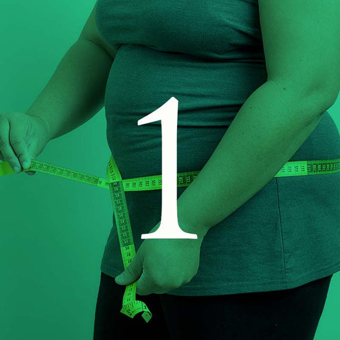 Person wearing a green shirt with a measuring tape around their waist on a green background