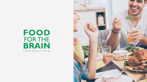 Two people enjoying a meal together with 'Food for the Brain Foundation' text overlay.
