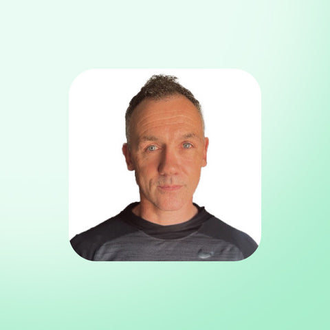 Christian Dailly wearing a dark shirt on a light green background