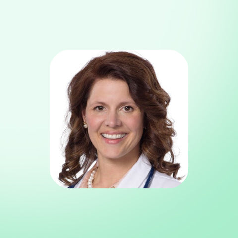 Dr Annette Bosworth in a white coat on a light green background