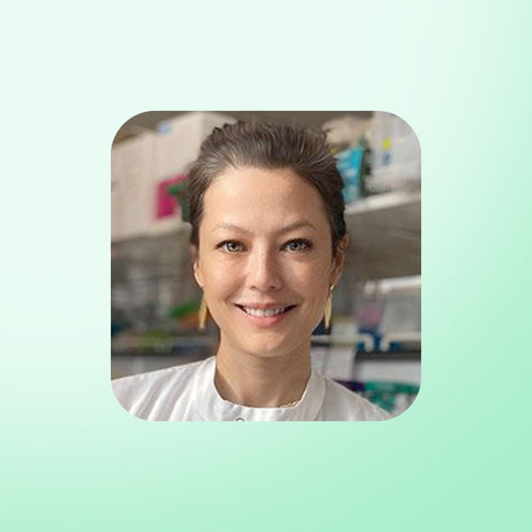 Isabella Cooper wearing a white shirt in a laboratory setting with a light green border