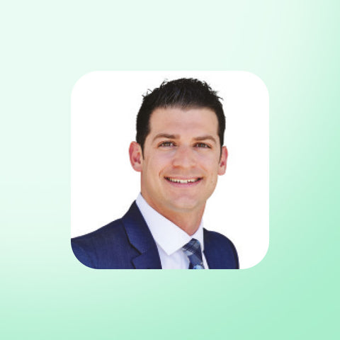 Dr James Dinicolantonio in a suit on a light green background