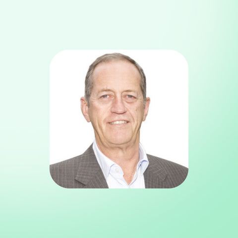 Dr Peter Brukner in a suit on a light green background
