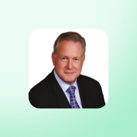 Dr Robert Lustig in a suit with a light green background