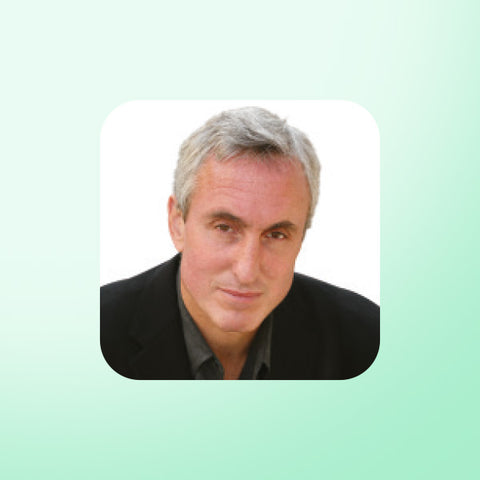 Gary Taubes with gray hair wearing a black jacket on a light green background