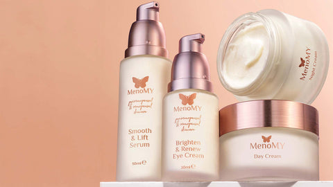 Menomy skincare products including serum, eye cream, and day cream on a golden background