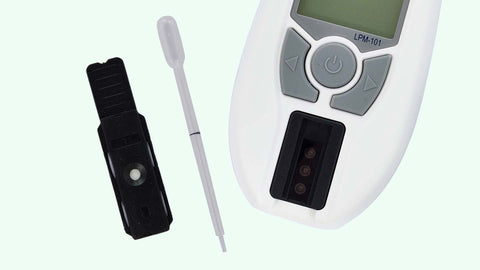 Blood lipid monitor and lipid strip on a light green background