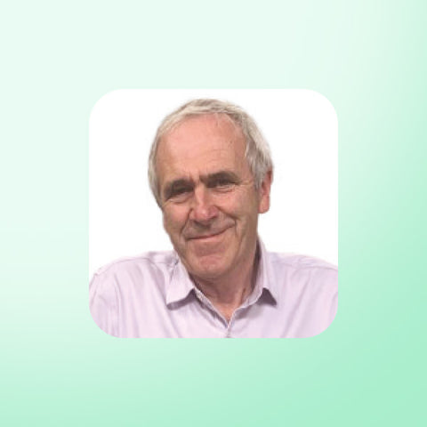 Patrick Holden CBE wearing a light purple shirt on a light green background