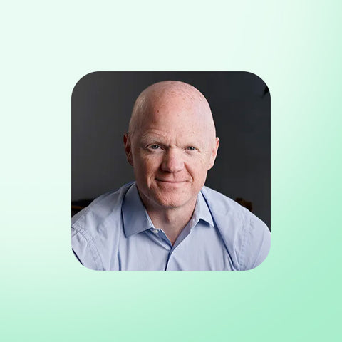 Professor Ben Bikman wearing a light blue shirt on a light green background
