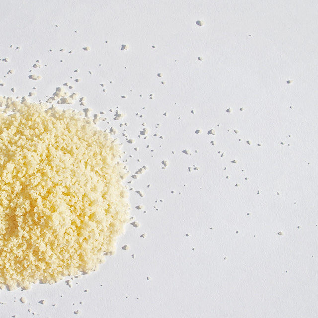 Yellow powder on a light gray background