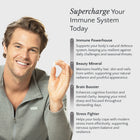 Man holding a supplement with text about immune system support on a light gray background