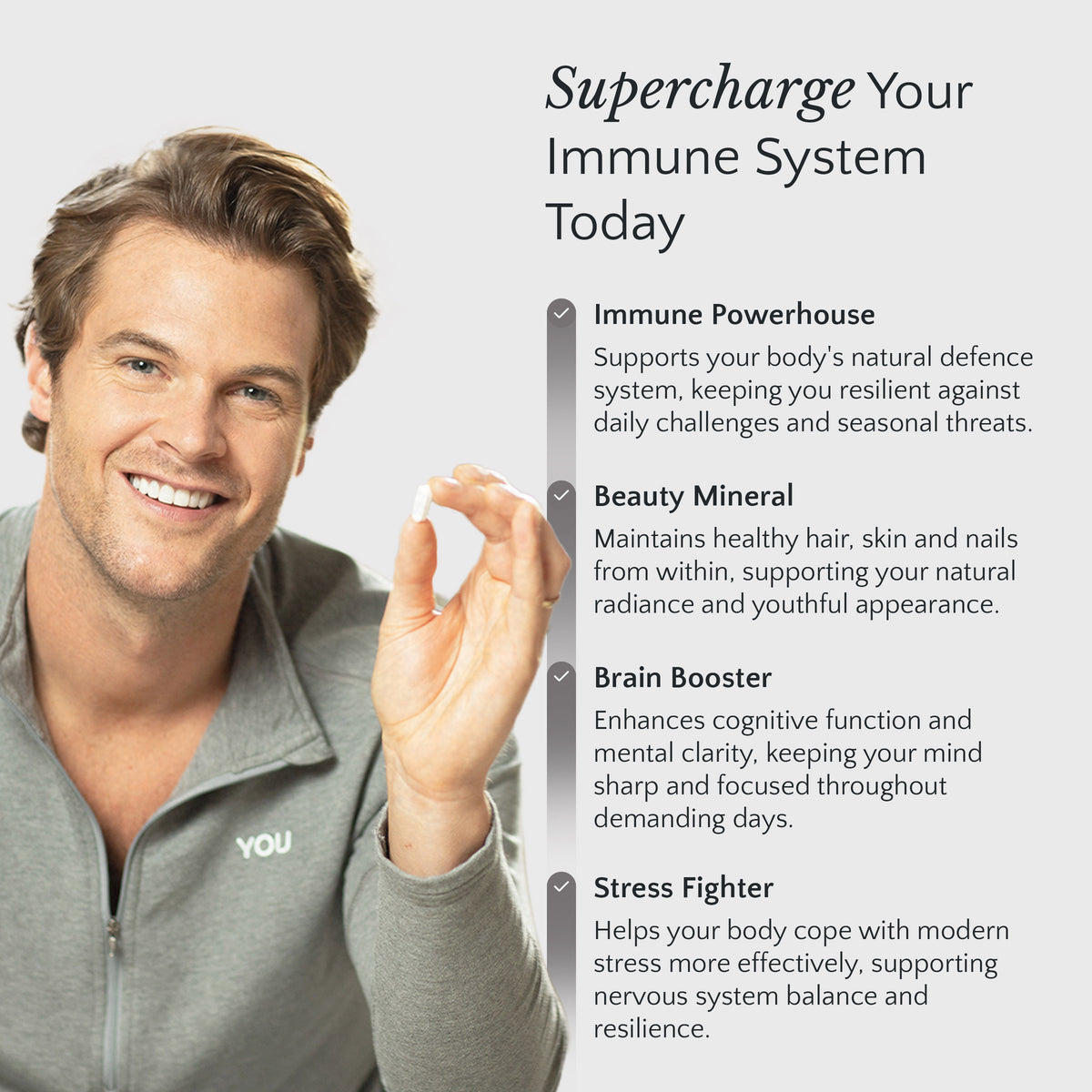 Man holding a supplement with text about immune system support on a light gray background
